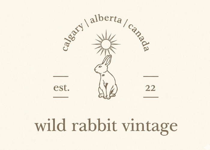 Logo of Wild Rabbit Vintage with a rabbit illustration and text on a beige background